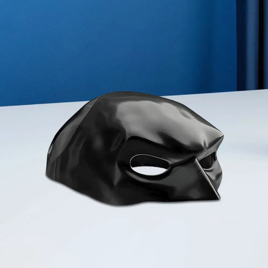 Black bird beak mask on white table with blue background