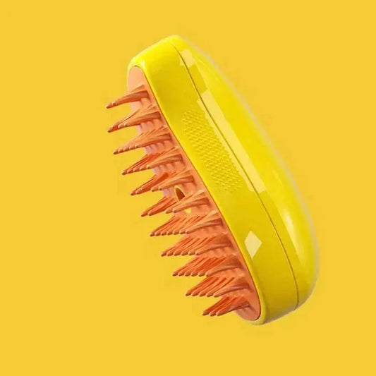 Yellow silicone scalp massager brush with orange bristles on a solid yellow background